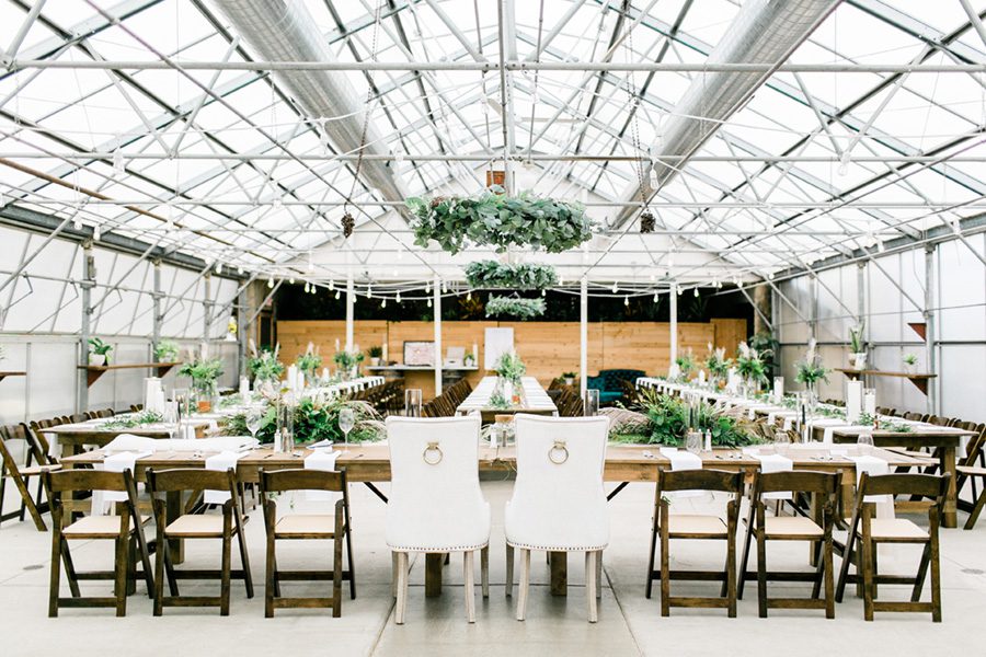 modern greenhouse wedding photos, carly mccray photography, lake geneva wedding photographer, madison wedding photographers, modern greenery wedding, modern wisconsin greenhouse wedding, modern greenery wedding, sleek wedding dress, greenery boutonnieres, black taper candles, green florals, modern greens