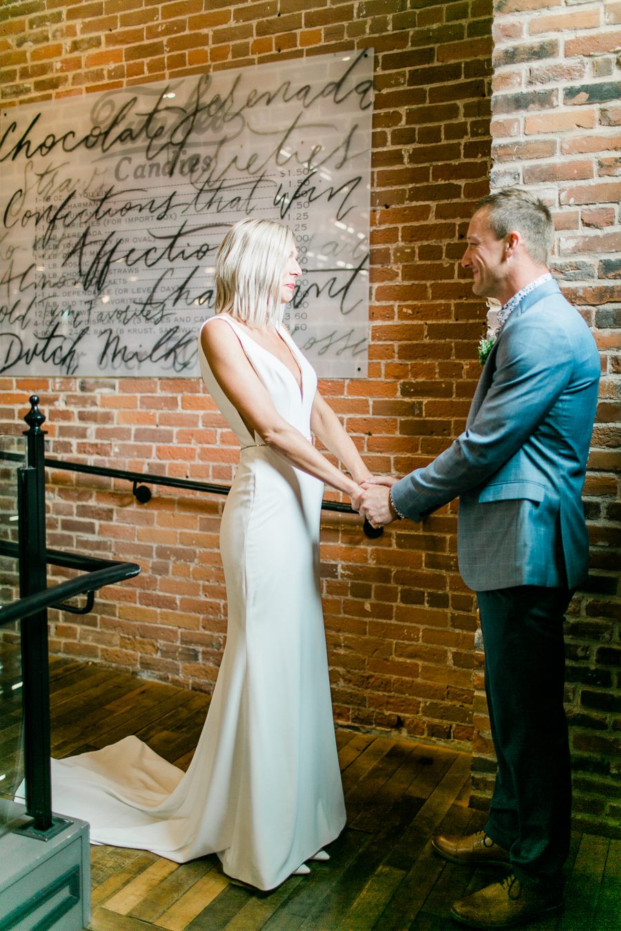 modern greenhouse wedding photos, carly mccray photography, lake geneva wedding photographer, madison wedding photographers, modern greenery wedding, modern wisconsin greenhouse wedding, modern greenery wedding, sleek wedding dress, greenery boutonnieres, black taper candles, green florals, modern greens