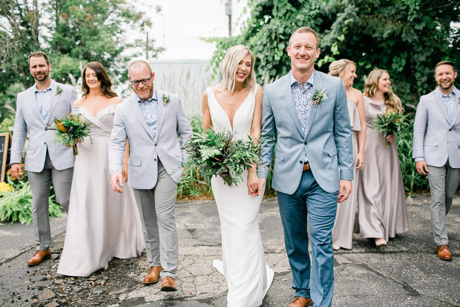 modern greenhouse wedding photos, carly mccray photography, lake geneva wedding photographer, madison wedding photographers, modern greenery wedding, modern wisconsin greenhouse wedding, modern greenery wedding, sleek wedding dress, greenery boutonnieres, black taper candles, green florals, modern greens