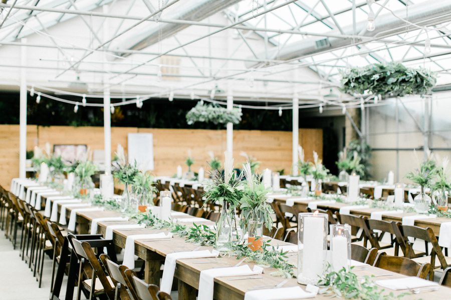 modern greenhouse wedding photos, carly mccray photography, lake geneva wedding photographer, madison wedding photographers, modern greenery wedding, modern wisconsin greenhouse wedding, modern greenery wedding, sleek wedding dress, greenery boutonnieres, black taper candles, green florals, modern greens