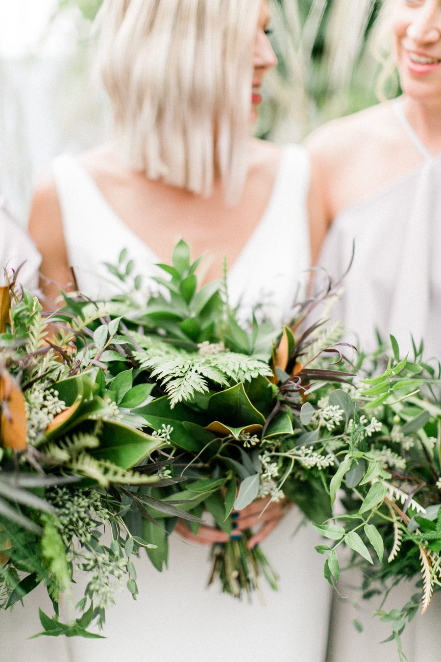 modern greenhouse wedding photos, carly mccray photography, lake geneva wedding photographer, madison wedding photographers, modern greenery wedding, modern wisconsin greenhouse wedding, modern greenery wedding, sleek wedding dress, greenery boutonnieres, black taper candles, green florals, modern greens