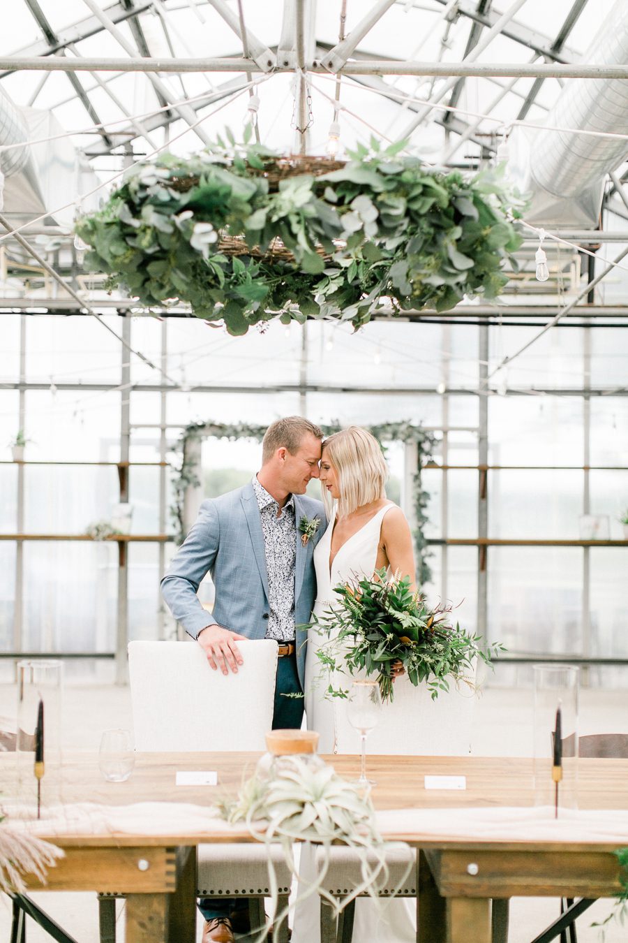 modern greenhouse wedding photos, carly mccray photography, lake geneva wedding photographer, madison wedding photographers, modern greenery wedding, modern wisconsin greenhouse wedding, modern greenery wedding, sleek wedding dress, greenery boutonnieres, black taper candles, green florals, modern greens