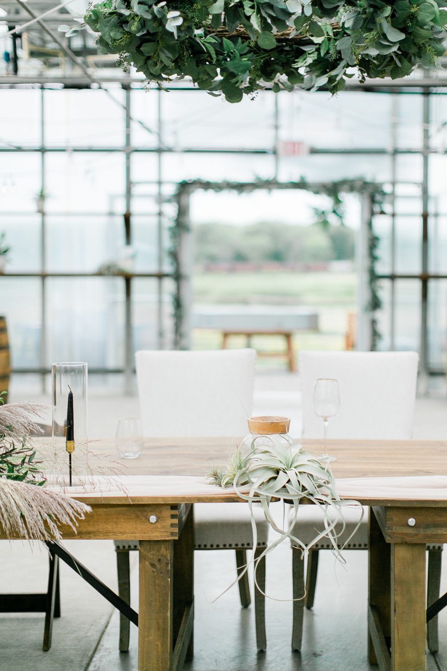 modern greenhouse wedding photos, carly mccray photography, lake geneva wedding photographer, madison wedding photographers, modern greenery wedding, modern wisconsin greenhouse wedding, modern greenery wedding, sleek wedding dress, greenery boutonnieres, black taper candles, green florals, modern greens