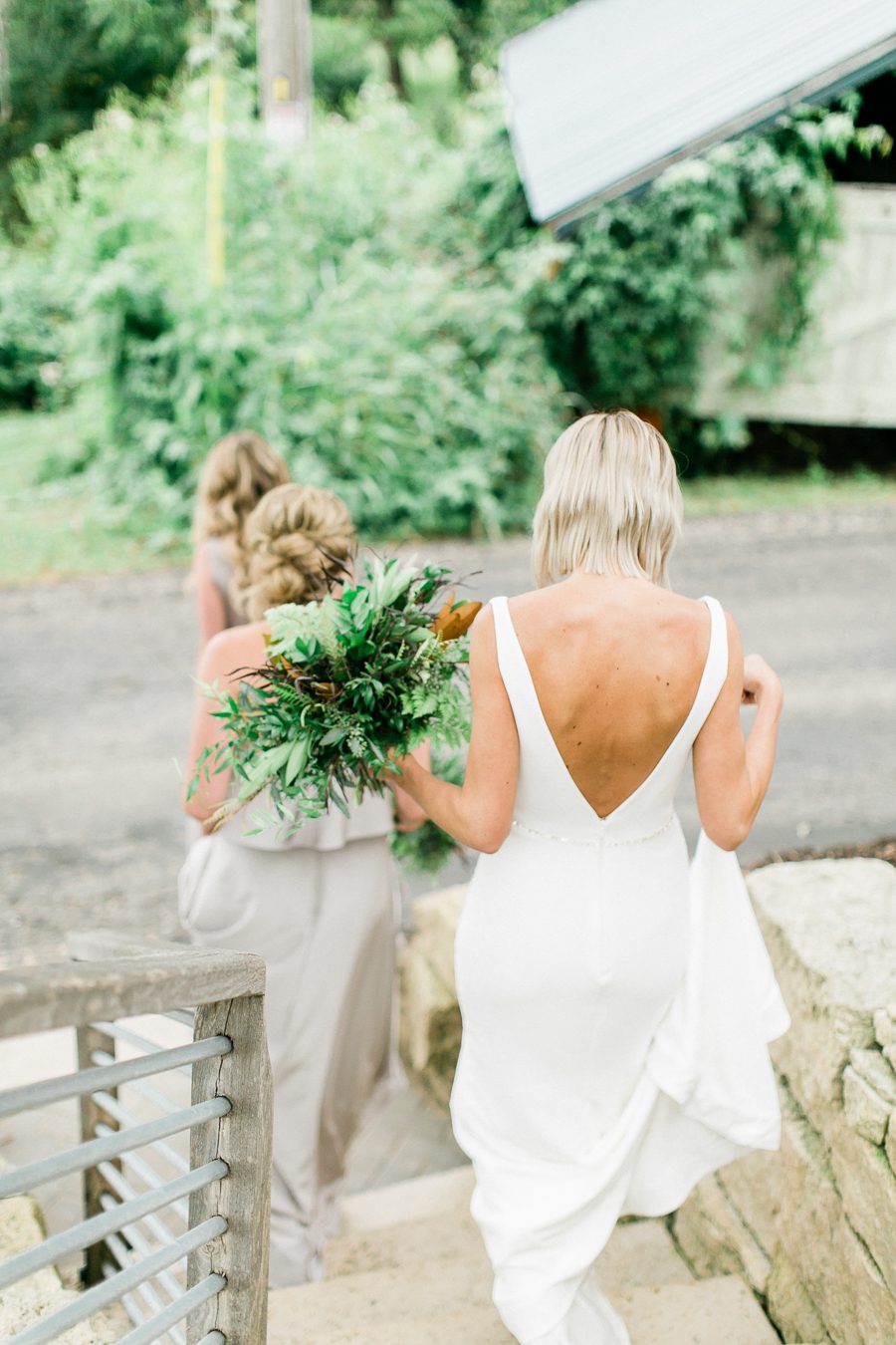 modern greenhouse wedding photos, carly mccray photography, lake geneva wedding photographer, madison wedding photographers, modern greenery wedding, modern wisconsin greenhouse wedding, modern greenery wedding, sleek wedding dress, greenery boutonnieres, black taper candles, green florals, modern greens