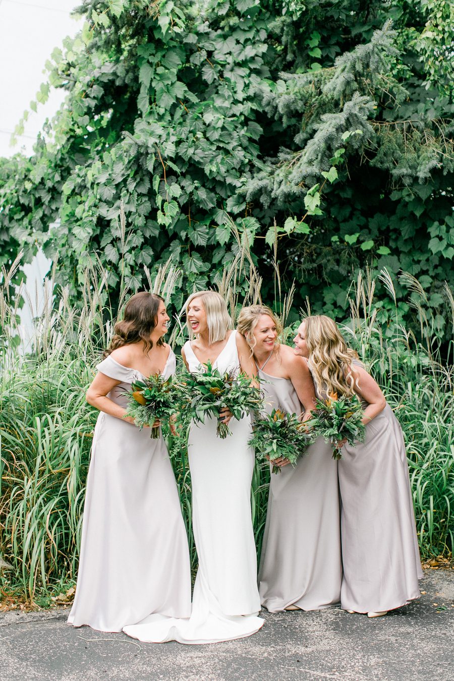 modern greenhouse wedding photos, carly mccray photography, lake geneva wedding photographer, madison wedding photographers, modern greenery wedding, modern wisconsin greenhouse wedding, modern greenery wedding, sleek wedding dress, greenery boutonnieres, black taper candles, green florals, modern greens