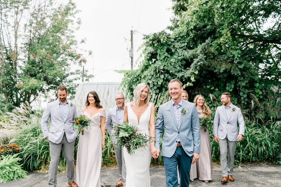 modern greenhouse wedding photos, carly mccray photography, lake geneva wedding photographer, madison wedding photographers, modern greenery wedding, modern wisconsin greenhouse wedding, modern greenery wedding, sleek wedding dress, greenery boutonnieres, black taper candles, green florals, modern greens