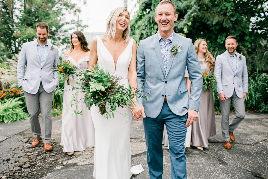 modern greenhouse wedding photos, carly mccray photography, lake geneva wedding photographer, madison wedding photographers, modern greenery wedding, modern wisconsin greenhouse wedding, modern greenery wedding, sleek wedding dress, greenery boutonnieres, black taper candles, green florals, modern greens