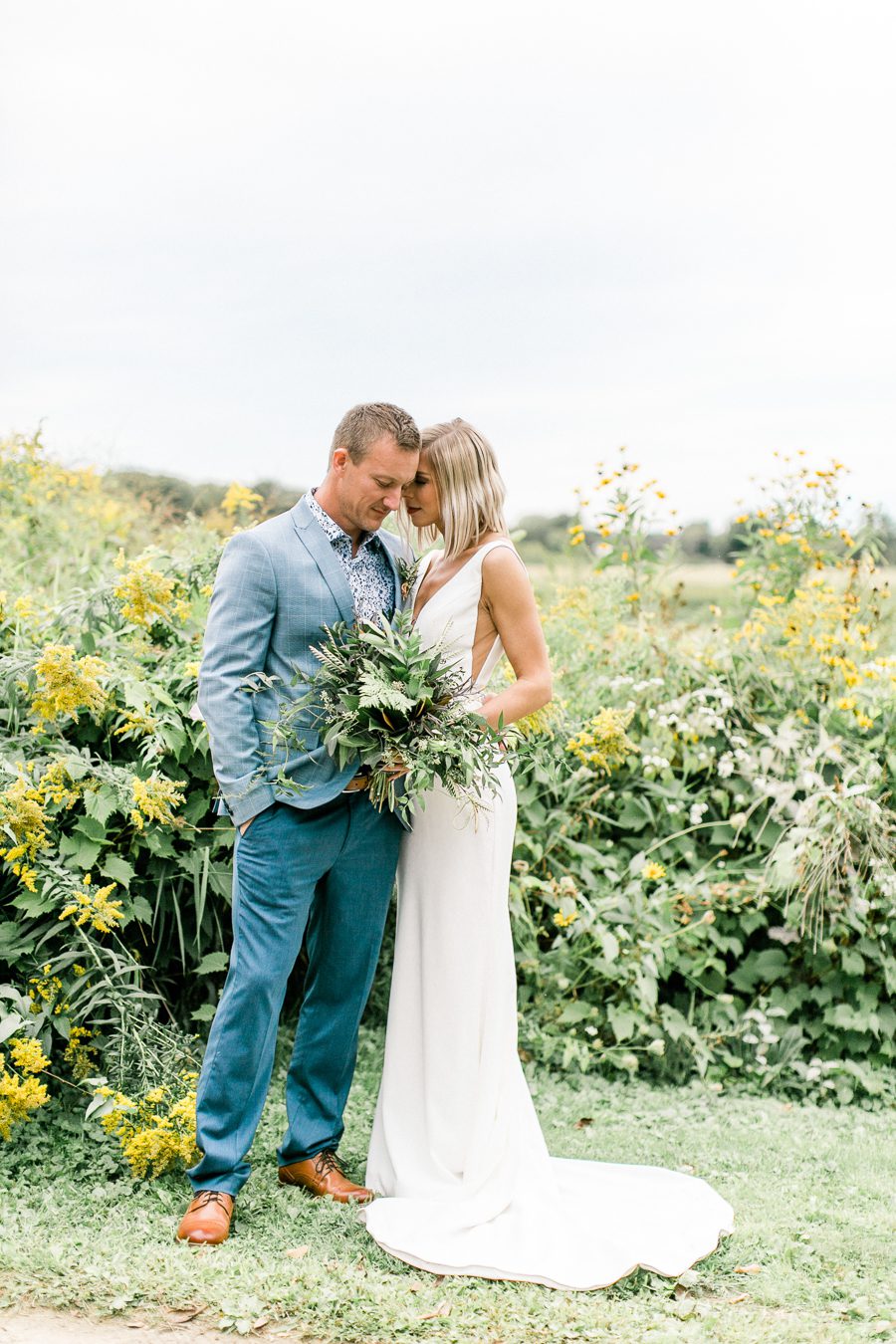 modern greenhouse wedding photos, carly mccray photography, lake geneva wedding photographer, madison wedding photographers, modern greenery wedding, modern wisconsin greenhouse wedding, modern greenery wedding, sleek wedding dress, greenery boutonnieres, black taper candles, green florals, modern greens