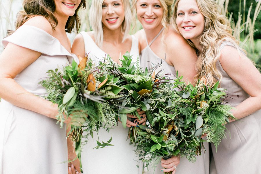 modern greenhouse wedding photos, carly mccray photography, lake geneva wedding photographer, madison wedding photographers, modern greenery wedding, modern wisconsin greenhouse wedding, modern greenery wedding, sleek wedding dress, greenery boutonnieres, black taper candles, green florals, modern greens