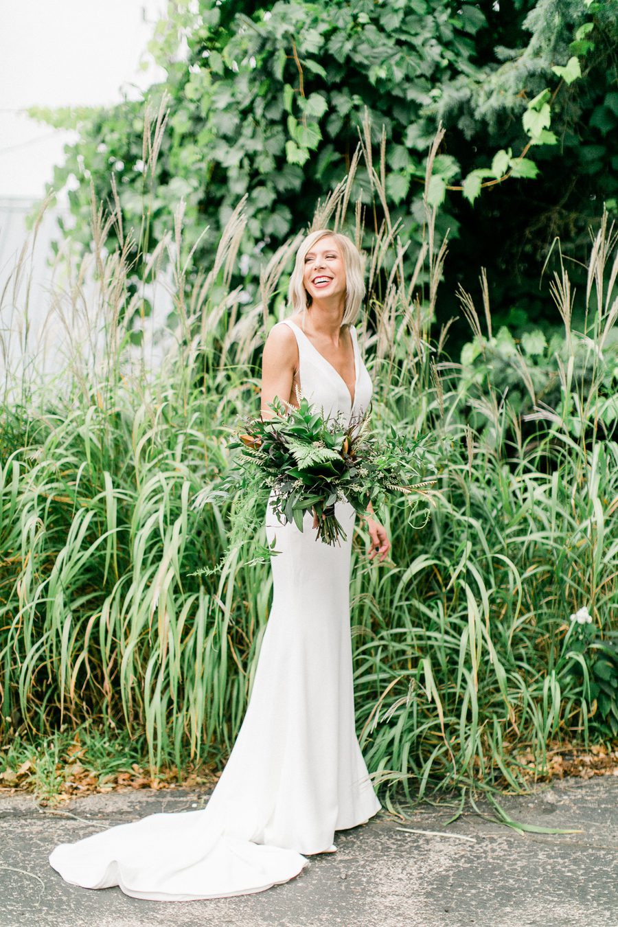 modern greenhouse wedding photos, carly mccray photography, lake geneva wedding photographer, madison wedding photographers, modern greenery wedding, modern wisconsin greenhouse wedding, modern greenery wedding, sleek wedding dress, greenery boutonnieres, black taper candles, green florals, modern greens