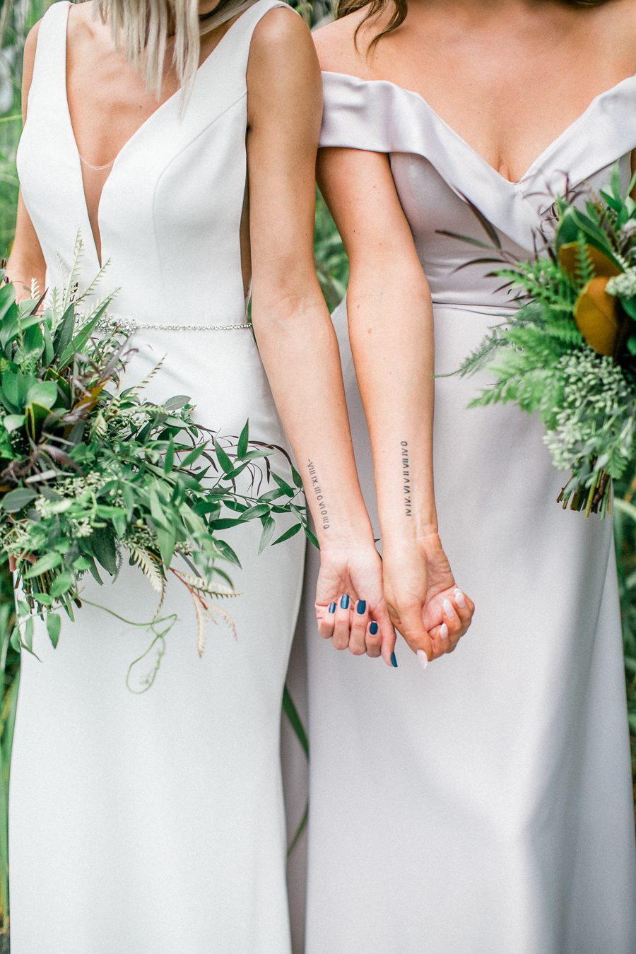 modern greenhouse wedding photos, carly mccray photography, lake geneva wedding photographer, madison wedding photographers, modern greenery wedding, modern wisconsin greenhouse wedding, modern greenery wedding, sleek wedding dress, greenery boutonnieres, black taper candles, green florals, modern greens