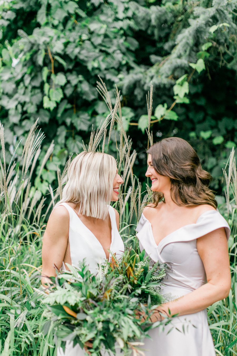 modern greenhouse wedding photos, carly mccray photography, lake geneva wedding photographer, madison wedding photographers, modern greenery wedding, modern wisconsin greenhouse wedding, modern greenery wedding, sleek wedding dress, greenery boutonnieres, black taper candles, green florals, modern greens