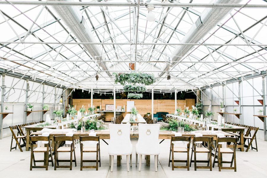 modern greenhouse wedding photos, carly mccray photography, lake geneva wedding photographer, madison wedding photographers, modern greenery wedding, modern wisconsin greenhouse wedding, modern greenery wedding, sleek wedding dress, greenery boutonnieres, black taper candles, green florals, modern greens