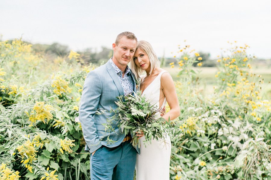 modern greenhouse wedding photos, carly mccray photography, lake geneva wedding photographer, madison wedding photographers, modern greenery wedding, modern wisconsin greenhouse wedding, modern greenery wedding, sleek wedding dress, greenery boutonnieres, black taper candles, green florals, modern greens