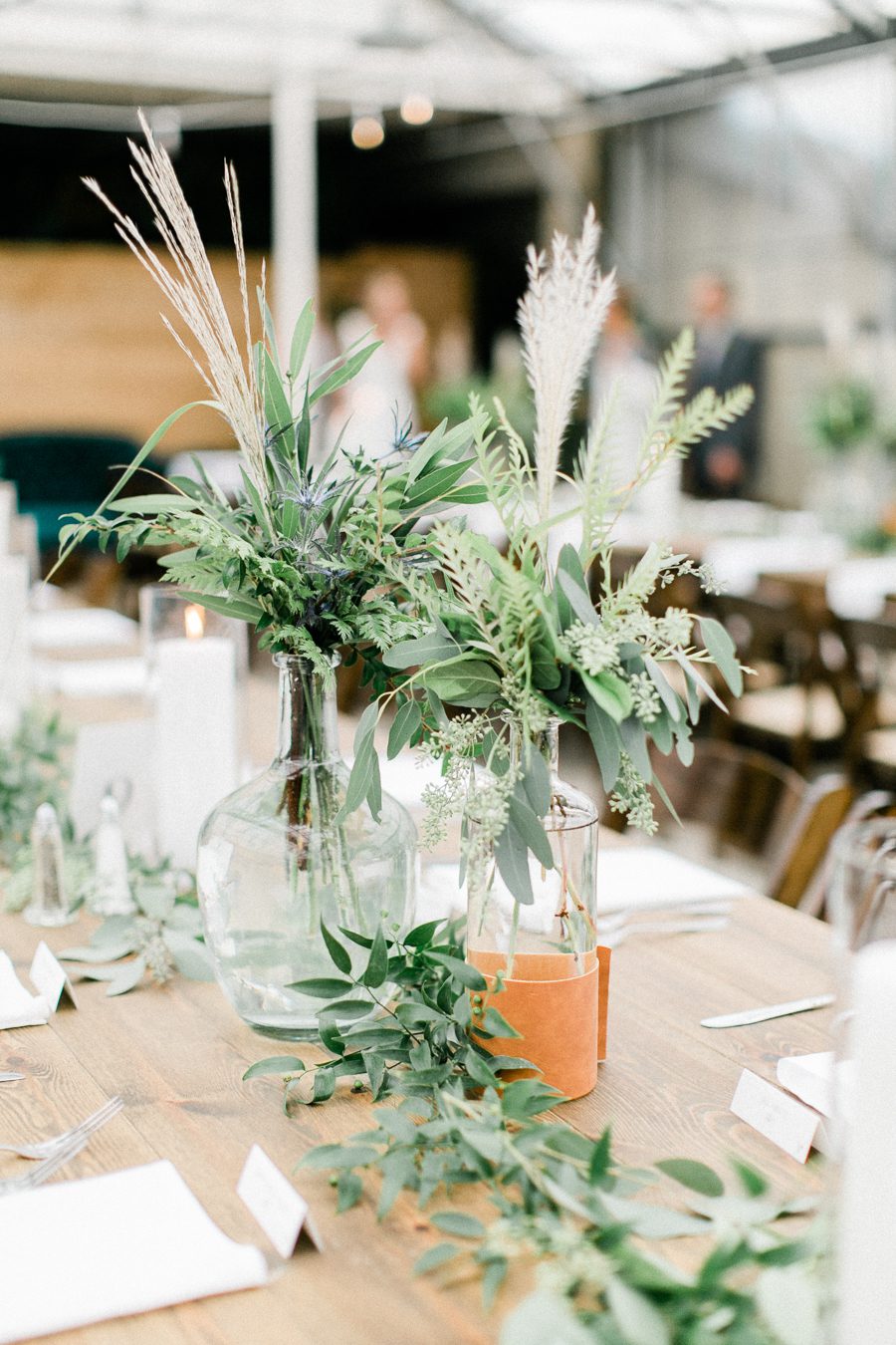 modern greenhouse wedding photos, carly mccray photography, lake geneva wedding photographer, madison wedding photographers, modern greenery wedding, modern wisconsin greenhouse wedding, modern greenery wedding, sleek wedding dress, greenery boutonnieres, black taper candles, green florals, modern greens