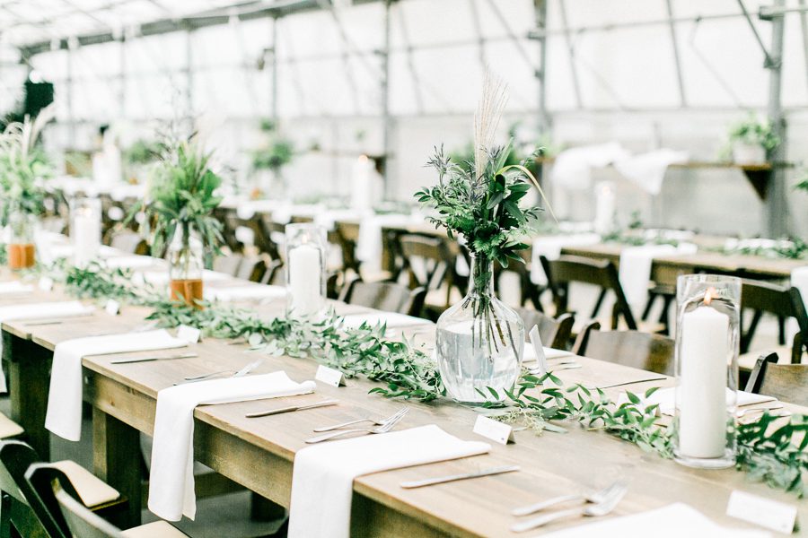 modern greenhouse wedding photos, carly mccray photography, lake geneva wedding photographer, madison wedding photographers, modern greenery wedding, modern wisconsin greenhouse wedding, modern greenery wedding, sleek wedding dress, greenery boutonnieres, black taper candles, green florals, modern greens