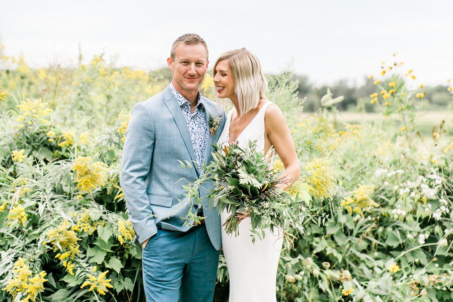 modern greenhouse wedding photos, carly mccray photography, lake geneva wedding photographer, madison wedding photographers, modern greenery wedding, modern wisconsin greenhouse wedding, modern greenery wedding, sleek wedding dress, greenery boutonnieres, black taper candles, green florals, modern greens