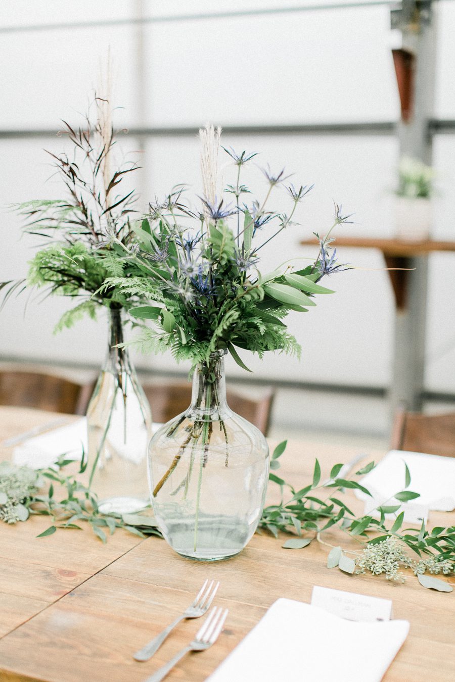 modern greenhouse wedding photos, carly mccray photography, lake geneva wedding photographer, madison wedding photographers, modern greenery wedding, modern wisconsin greenhouse wedding, modern greenery wedding, sleek wedding dress, greenery boutonnieres, black taper candles, green florals, modern greens