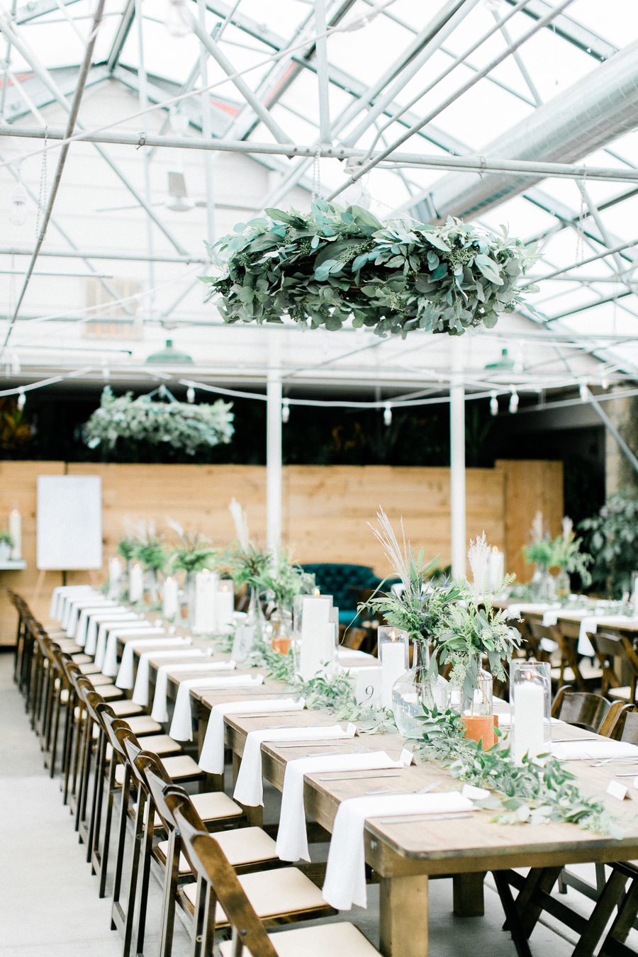 modern greenhouse wedding photos, carly mccray photography, lake geneva wedding photographer, madison wedding photographers, modern greenery wedding, modern wisconsin greenhouse wedding, modern greenery wedding, sleek wedding dress, greenery boutonnieres, black taper candles, green florals, modern greens