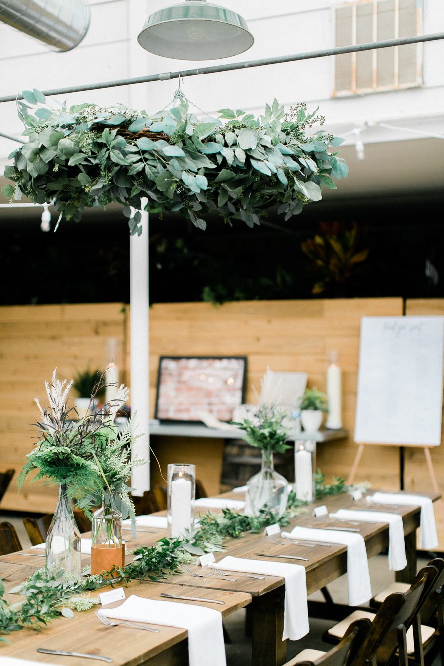 modern greenhouse wedding photos, carly mccray photography, lake geneva wedding photographer, madison wedding photographers, modern greenery wedding, modern wisconsin greenhouse wedding, modern greenery wedding, sleek wedding dress, greenery boutonnieres, black taper candles, green florals, modern greens