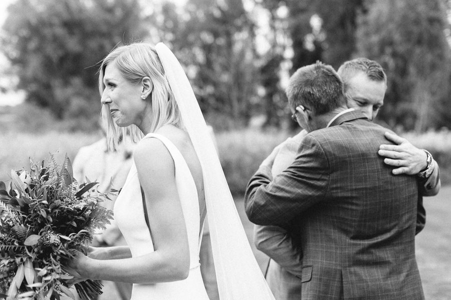 modern greenhouse wedding photos, carly mccray photography, lake geneva wedding photographer, madison wedding photographers, modern greenery wedding, modern wisconsin greenhouse wedding, modern greenery wedding, sleek wedding dress, greenery boutonnieres, black taper candles, green florals, modern greens