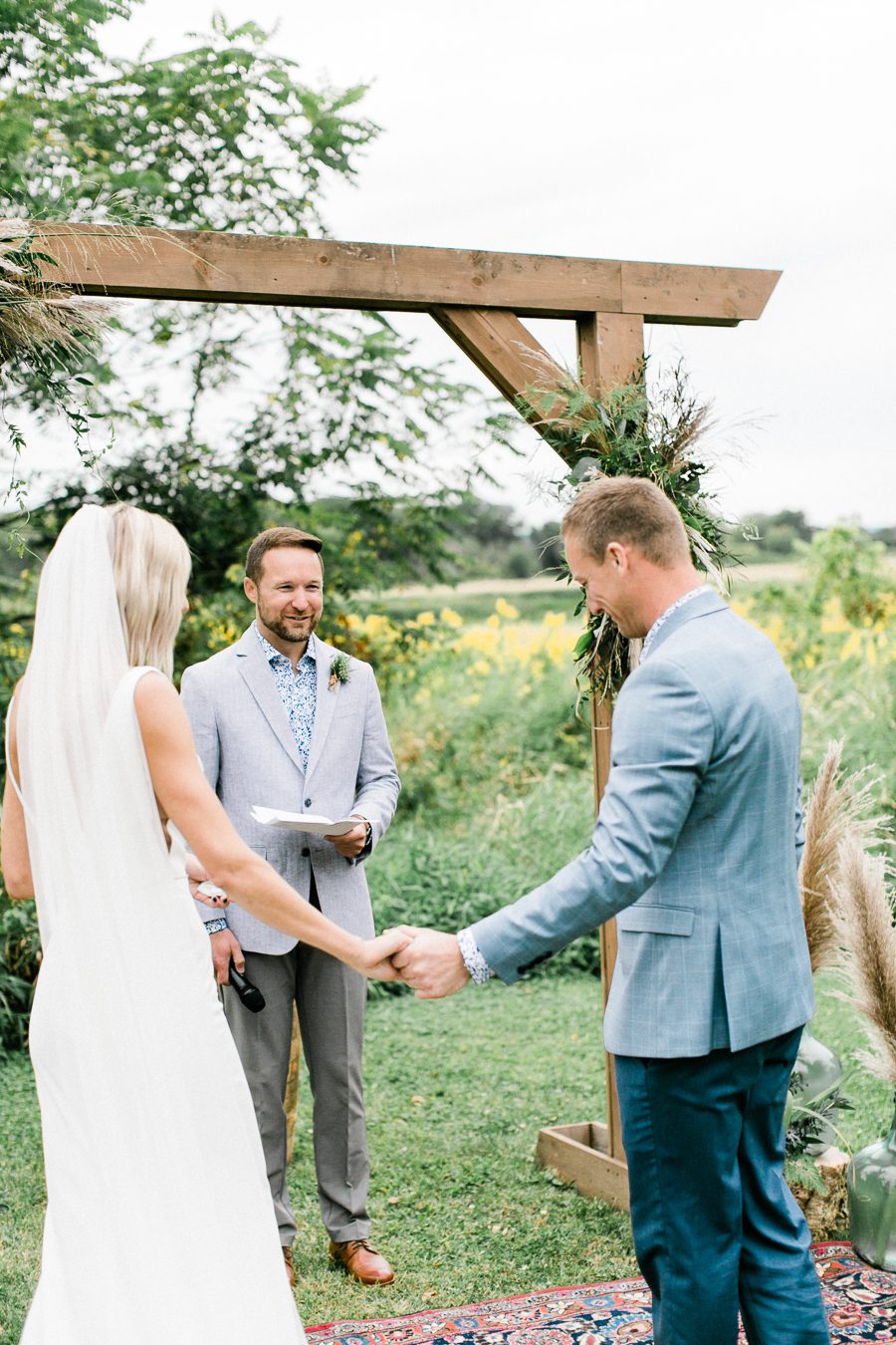 modern greenhouse wedding photos, carly mccray photography, lake geneva wedding photographer, madison wedding photographers, modern greenery wedding, modern wisconsin greenhouse wedding, modern greenery wedding, sleek wedding dress, greenery boutonnieres, black taper candles, green florals, modern greens