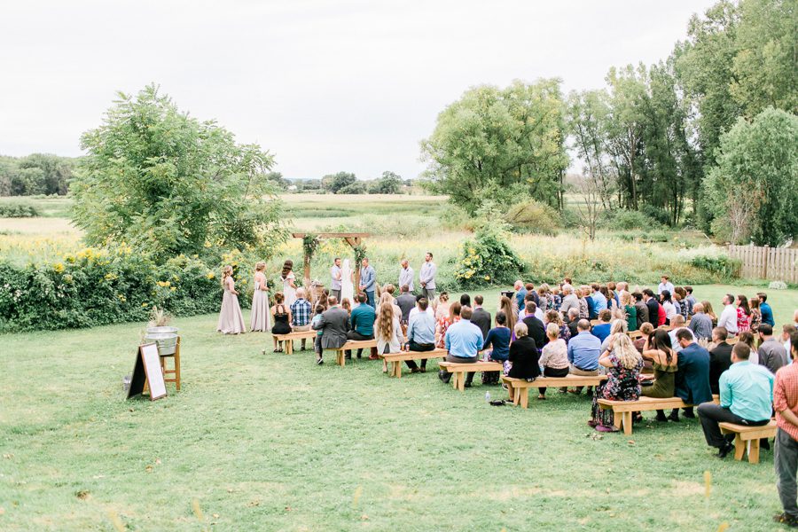 modern greenhouse wedding photos, carly mccray photography, lake geneva wedding photographer, madison wedding photographers, modern greenery wedding, modern wisconsin greenhouse wedding, modern greenery wedding, sleek wedding dress, greenery boutonnieres, black taper candles, green florals, modern greens