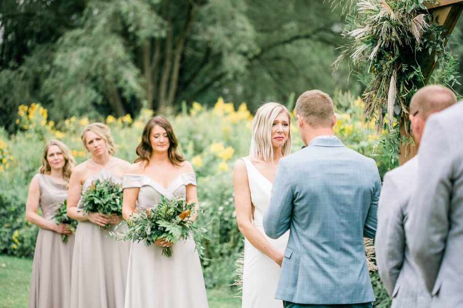 modern greenhouse wedding photos, carly mccray photography, lake geneva wedding photographer, madison wedding photographers, modern greenery wedding, modern wisconsin greenhouse wedding, modern greenery wedding, sleek wedding dress, greenery boutonnieres, black taper candles, green florals, modern greens