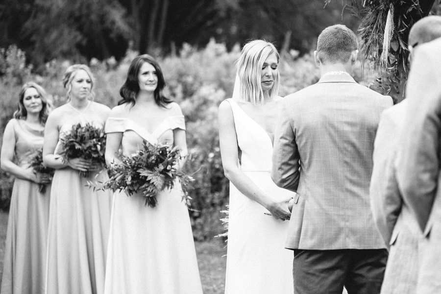 modern greenhouse wedding photos, carly mccray photography, lake geneva wedding photographer, madison wedding photographers, modern greenery wedding, modern wisconsin greenhouse wedding, modern greenery wedding, sleek wedding dress, greenery boutonnieres, black taper candles, green florals, modern greens