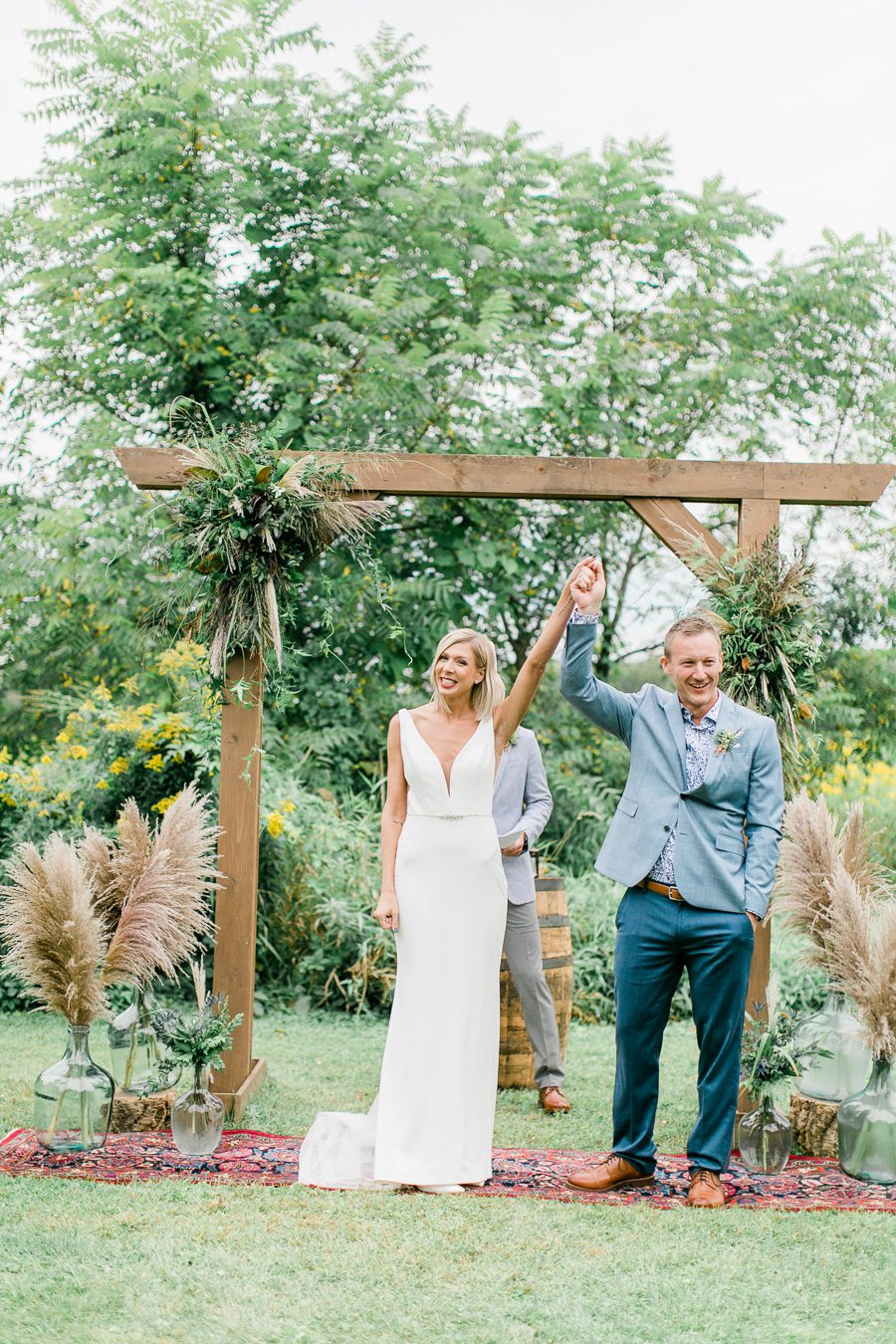 modern greenhouse wedding photos, carly mccray photography, lake geneva wedding photographer, madison wedding photographers, modern greenery wedding, modern wisconsin greenhouse wedding, modern greenery wedding, sleek wedding dress, greenery boutonnieres, black taper candles, green florals, modern greens