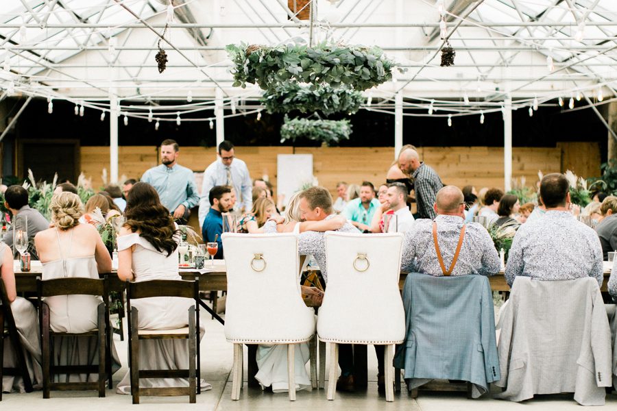 modern greenhouse wedding photos, carly mccray photography, lake geneva wedding photographer, madison wedding photographers, modern greenery wedding, modern wisconsin greenhouse wedding, modern greenery wedding, sleek wedding dress, greenery boutonnieres, black taper candles, green florals, modern greens