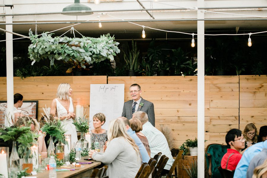 modern greenhouse wedding photos, carly mccray photography, lake geneva wedding photographer, madison wedding photographers, modern greenery wedding, modern wisconsin greenhouse wedding, modern greenery wedding, sleek wedding dress, greenery boutonnieres, black taper candles, green florals, modern greens