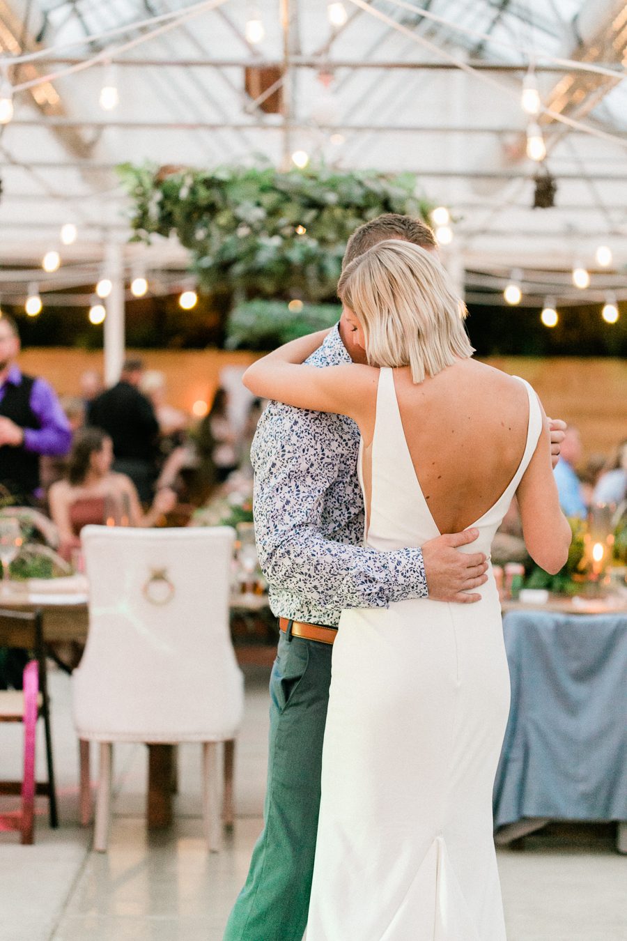 modern greenhouse wedding photos, carly mccray photography, lake geneva wedding photographer, madison wedding photographers, modern greenery wedding, modern wisconsin greenhouse wedding, modern greenery wedding, sleek wedding dress, greenery boutonnieres, black taper candles, green florals, modern greens