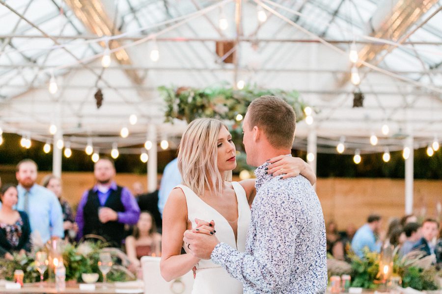 modern greenhouse wedding photos, carly mccray photography, lake geneva wedding photographer, madison wedding photographers, modern greenery wedding, modern wisconsin greenhouse wedding, modern greenery wedding, sleek wedding dress, greenery boutonnieres, black taper candles, green florals, modern greens