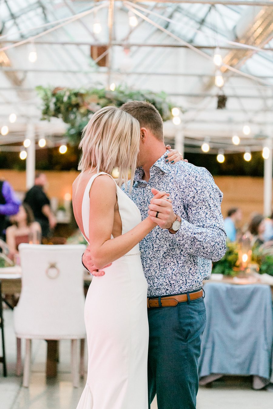 modern greenhouse wedding photos, carly mccray photography, lake geneva wedding photographer, madison wedding photographers, modern greenery wedding, modern wisconsin greenhouse wedding, modern greenery wedding, sleek wedding dress, greenery boutonnieres, black taper candles, green florals, modern greens