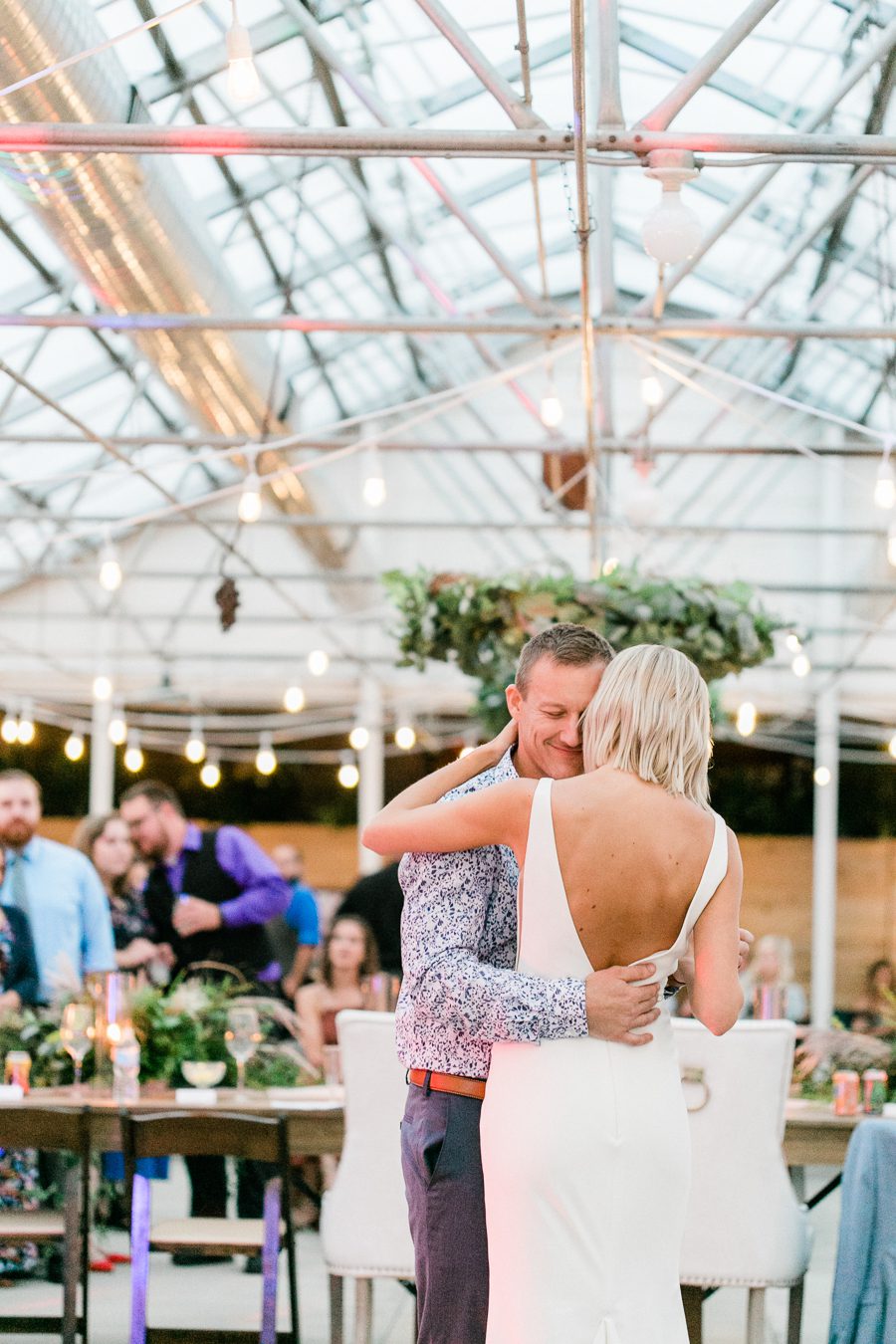 modern greenhouse wedding photos, carly mccray photography, lake geneva wedding photographer, madison wedding photographers, modern greenery wedding, modern wisconsin greenhouse wedding, modern greenery wedding, sleek wedding dress, greenery boutonnieres, black taper candles, green florals, modern greens