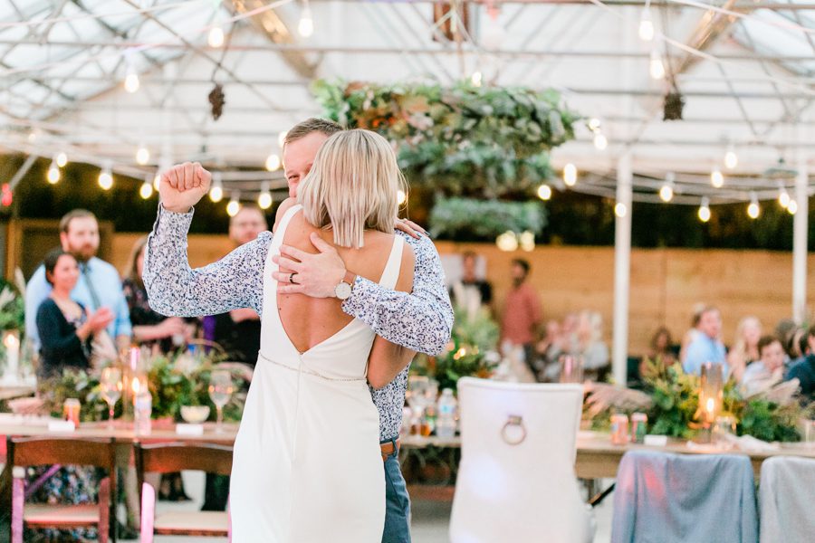 modern greenhouse wedding photos, carly mccray photography, lake geneva wedding photographer, madison wedding photographers, modern greenery wedding, modern wisconsin greenhouse wedding, modern greenery wedding, sleek wedding dress, greenery boutonnieres, black taper candles, green florals, modern greens