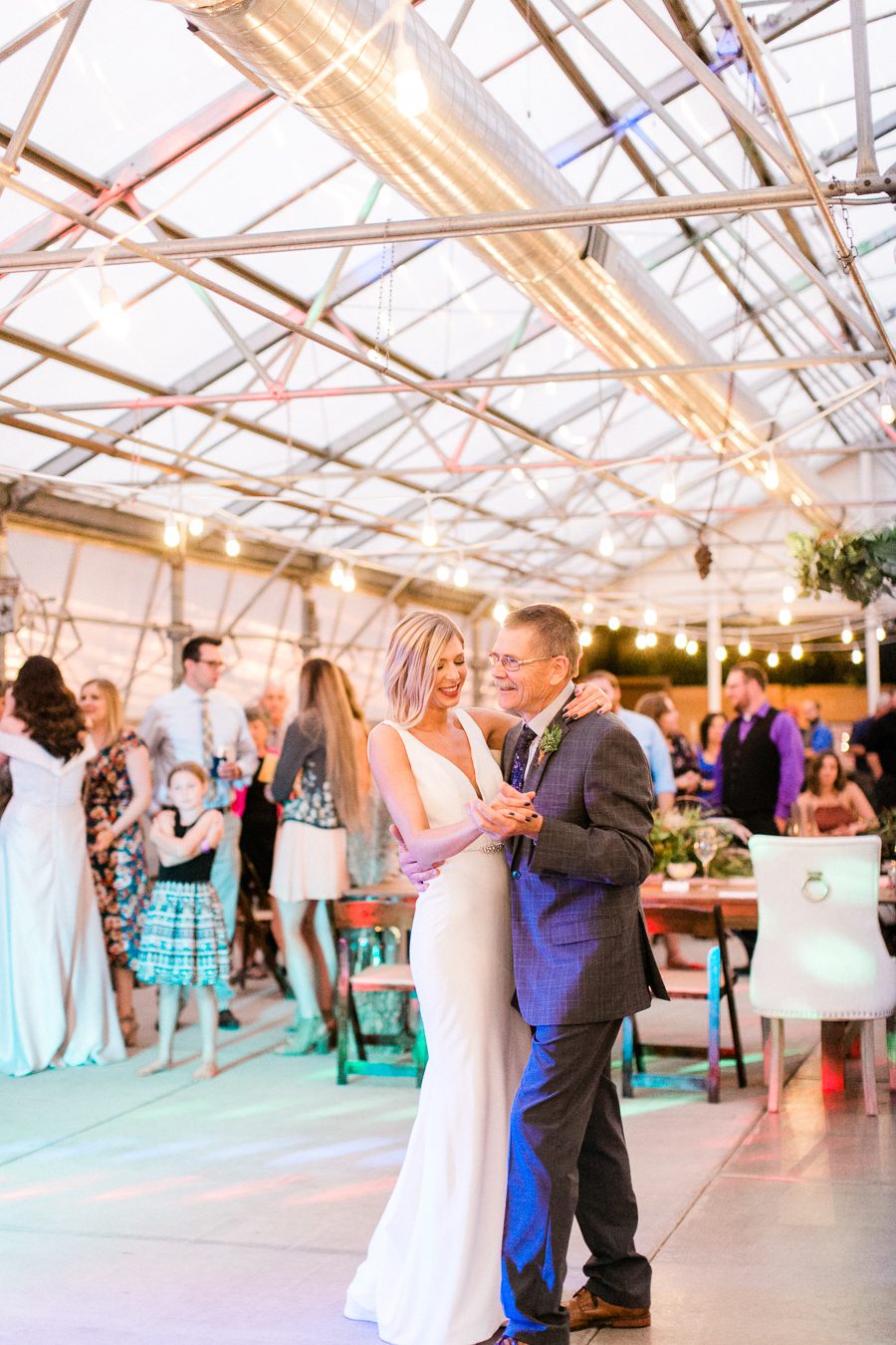 modern greenhouse wedding photos, carly mccray photography, lake geneva wedding photographer, madison wedding photographers, modern greenery wedding, modern wisconsin greenhouse wedding, modern greenery wedding, sleek wedding dress, greenery boutonnieres, black taper candles, green florals, modern greens